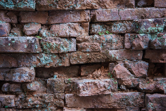 Old and broken red stone brick wall
