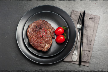 Sliced medium  Beef Steak Ribeye on black stone background