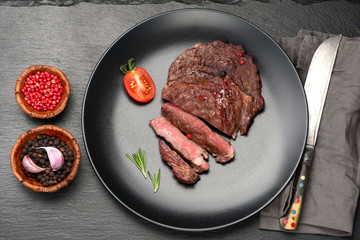 medium Beef Steak Ribeye on black stone background