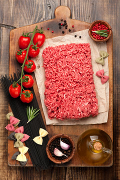 Italian food ingredients: minced beef, pasta, spaghetti, tomato and spices