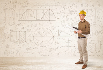 Handsome engineer calculating with hand drawn background