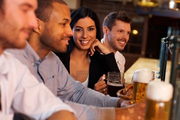 Young woman with friends in pub