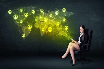 Fototapeta na wymiar Businesswoman in office with tablet and social network world map