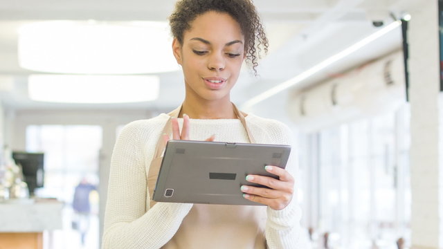 Waitress working with portable tablet. 