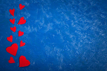 Red paper hearts on a blue background   Valentine's Day