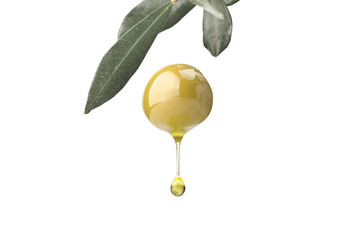 A drop of olive oil falling from one green olive on a white - 99656280