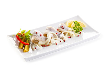 Marinated herring fillets on white background