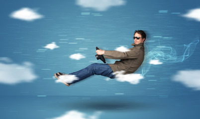 Funny racedriver young man driving between clouds concept
