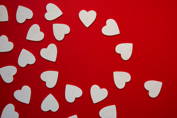 multiple hearts whites shapes, forming a circular frame, red bac