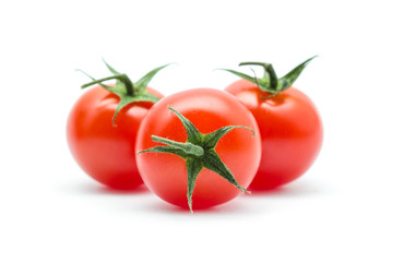 tomatoes with green leaves isolated on white background