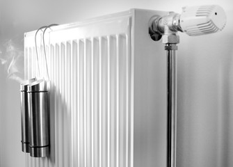 Steam from metal containers on radiator