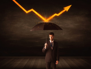 Businessman standing with umbrella keeping orange arrow