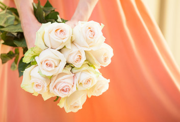 Unrecognizable young woman holding a bouquet of roses