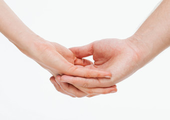 Man's hand gently holding woman's hand