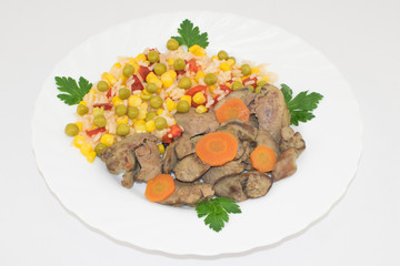 Cooked Hawaiian mixed vegetables with chicken liver, carrots, onion and parsley on a white plate