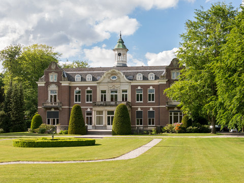 Manor estate Rusthoek surrounded by trees and lawn in Baarn, Netherlands