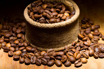 Coffee beans in fabric on a wooden