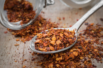 Chili flakes on metal spoon