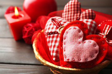 St Valentine's decor in basket on wooden background