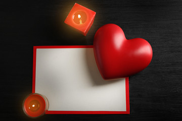 Card and St Valentine's decor on wooden background