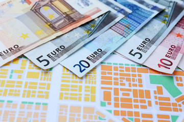 Different euro banknotes on a map background
