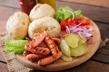 Ingredients for making Hot dog - sandwich with pickles, red onions and lettuce