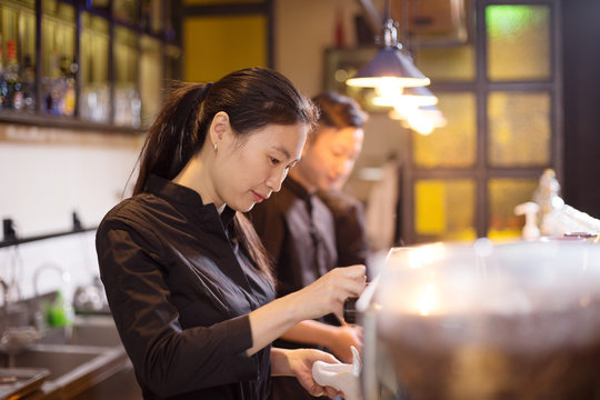 waitress serving in modern cafe
