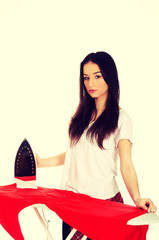 Young woman do the ironing.