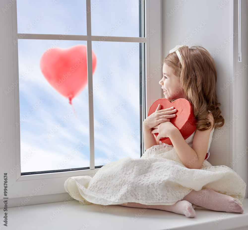 Wall mural girl with red heart.