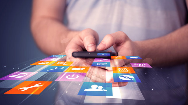 Man holding smart phone with colorful application icons