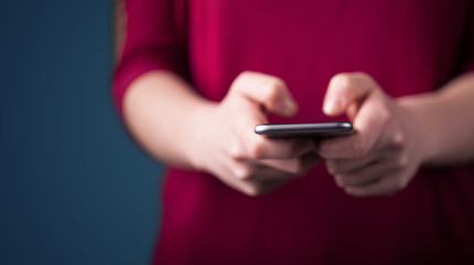 Young woman holding smarthphone in hand