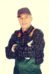 Mature gardener standing with folded arms