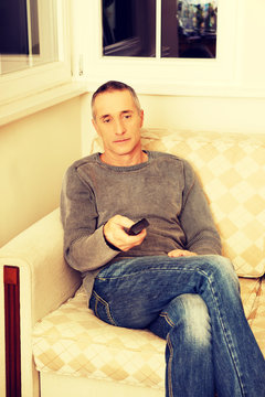 Mature man with remote control