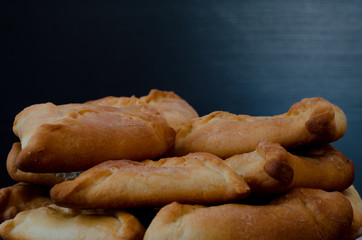 Plate with fresh fragrant pies on a black wooden table, lunch, echpochmak