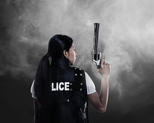 Beautiful police woman holding gun