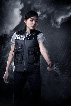 Beautiful police woman holding gun