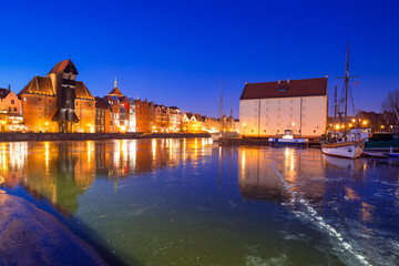 Fototapeta na wymiar Old town of Gdansk at frozen Motlawa river, Poland