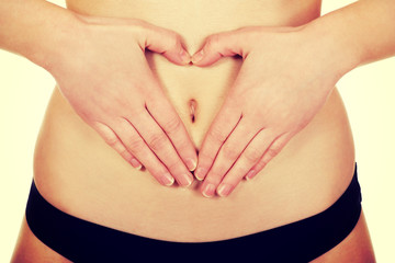 Woman with her hands on belly.