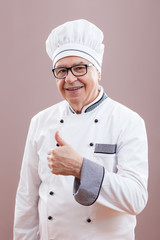 Portrait of happy restaurant's chef who is satisfied with his meal