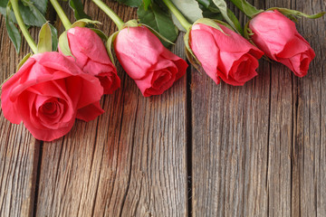 Roses bouquet on old wooden table