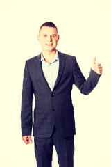 Young businessman gesturing ok sign