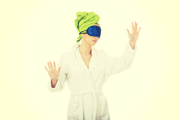 Sleepwalking woman in bathrobe.