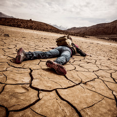 person lays on the dried ground