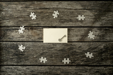 Top view of a key lying on a blank white piece of paper surround