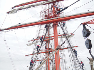 sailors climbing rigging of a huge tallship