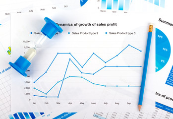 Financial chart with hourglass and blue pencil