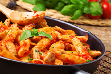 Penne with roasted chicken in tomato sauce
