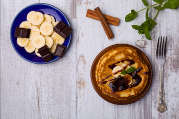 Delicious pancakes with bananas and chocolate.