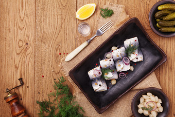 Rolled herring in vinegar, served with onions and pickles.