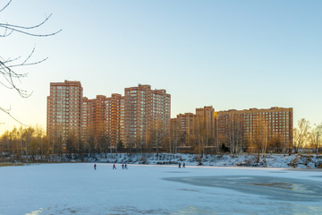 Fototapeta premium modern Russian city on the shore of a pond in winter 